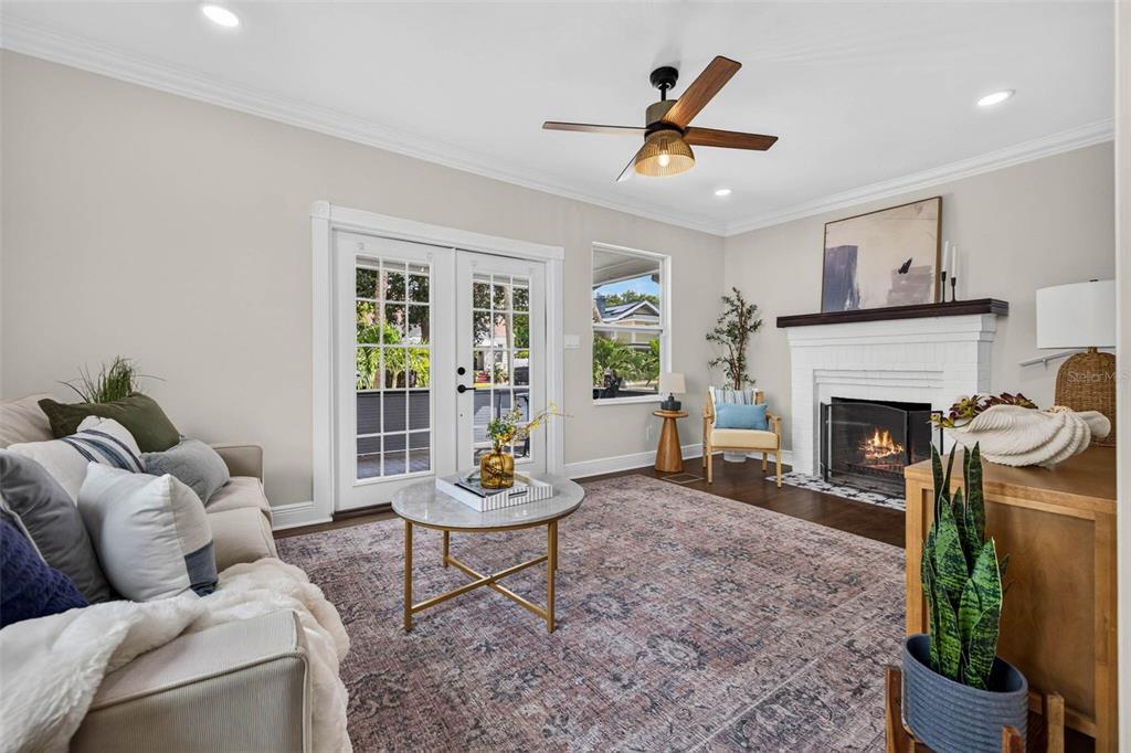 A living room features a white brick fireplace, a ceiling fan, and French doors — 629 6TH AVENUE N, ST PETERSBURG, FL
