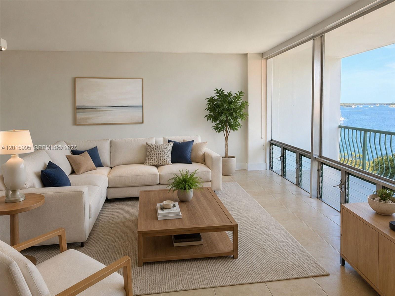 A furnished balcony overlooks the ocean with a view of an adjacent high-rise building — 1408 Brickell Bay Dr # 1104, Miami FL 33131, MIAMI, FL