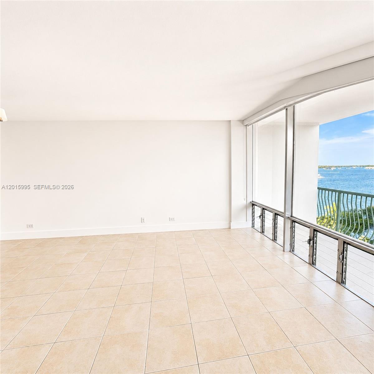A balcony with a dark metal railing overlooks a wide bay with several boats — 1408 Brickell Bay Dr # 1104, Miami FL 33131, MIAMI, FL