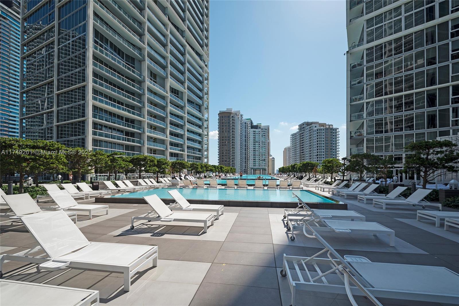 An elevated view of a waterfront city skyline featuring a tall building under construction — 485 Brickell Ave # 2603, Miami FL 33131, MIAMI, FL