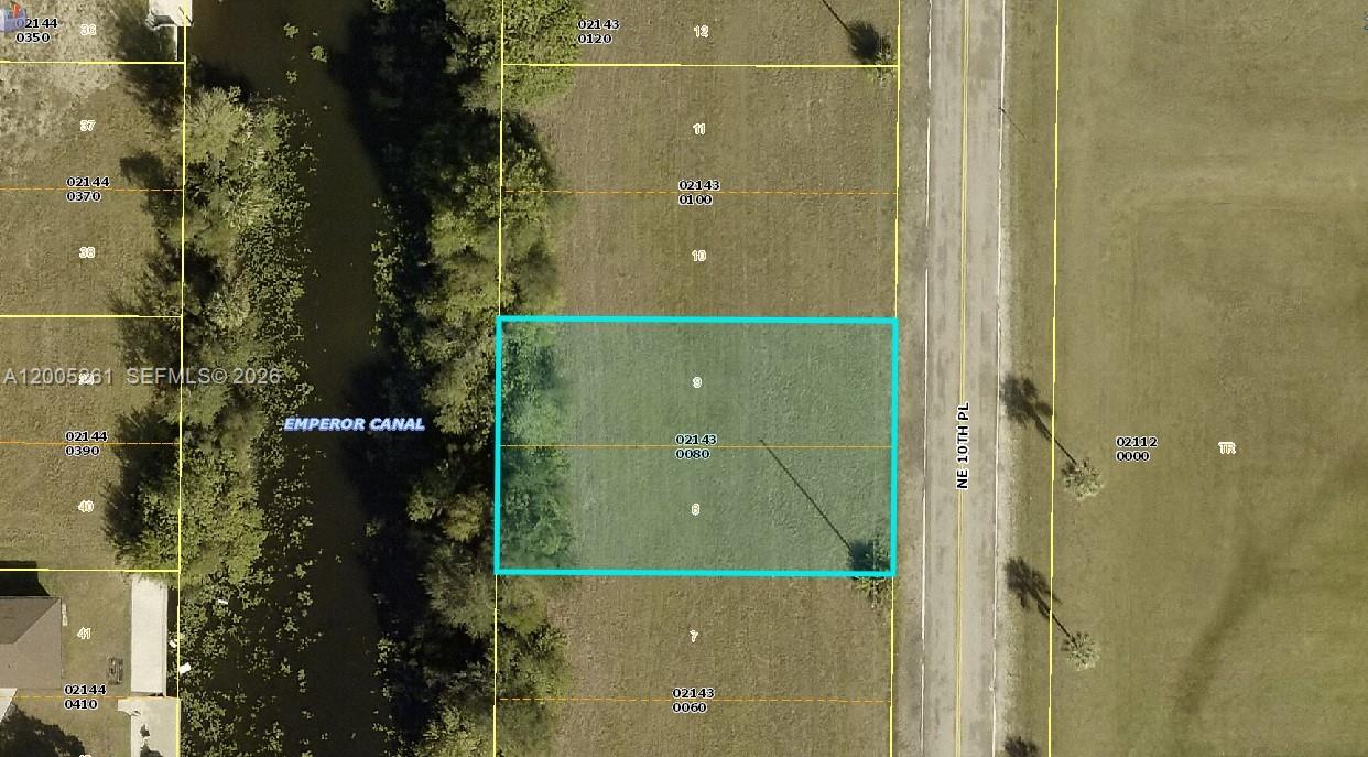 This is an aerial map showing a vacant rectangular lot bordered by a canal — 1702 NE 10th PL, Cape Coral FL 33909, CAPE CORAL, FL