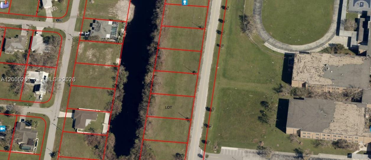 This is an aerial map showing a vacant lot situated between a canal and road — 1702 NE 10th PL, Cape Coral FL 33909, CAPE CORAL, FL