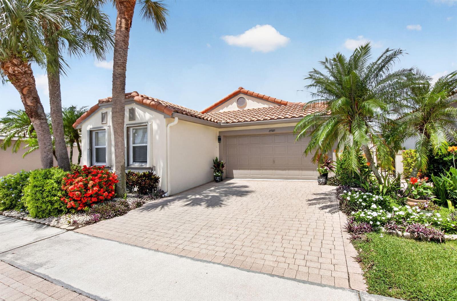 A single-story house with a tiled roof, beige stucco exterior, and a paved driveway — 11585 Augustus Drive, Boynton Beach FL 33437, BOYNTON BEACH, FL