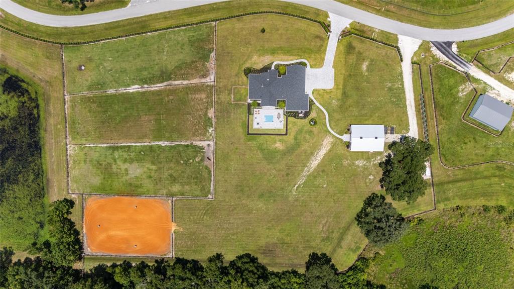 An aerial view shows a house with a pool, a barn, and a riding arena — 11098 NW 50TH LANE, OCALA, FL