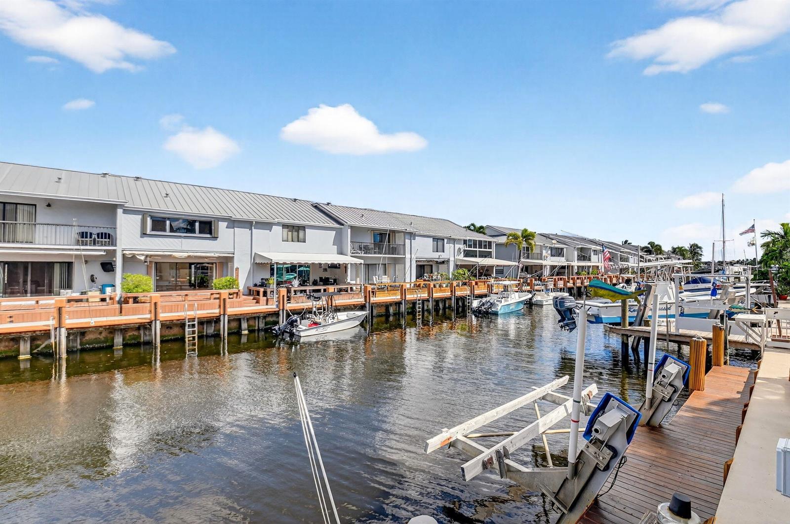 A row of waterfront townhouses with private docks and boats along a canal — 732 Rider Road, Boynton Beach FL 33435, BOYNTON BEACH, FL