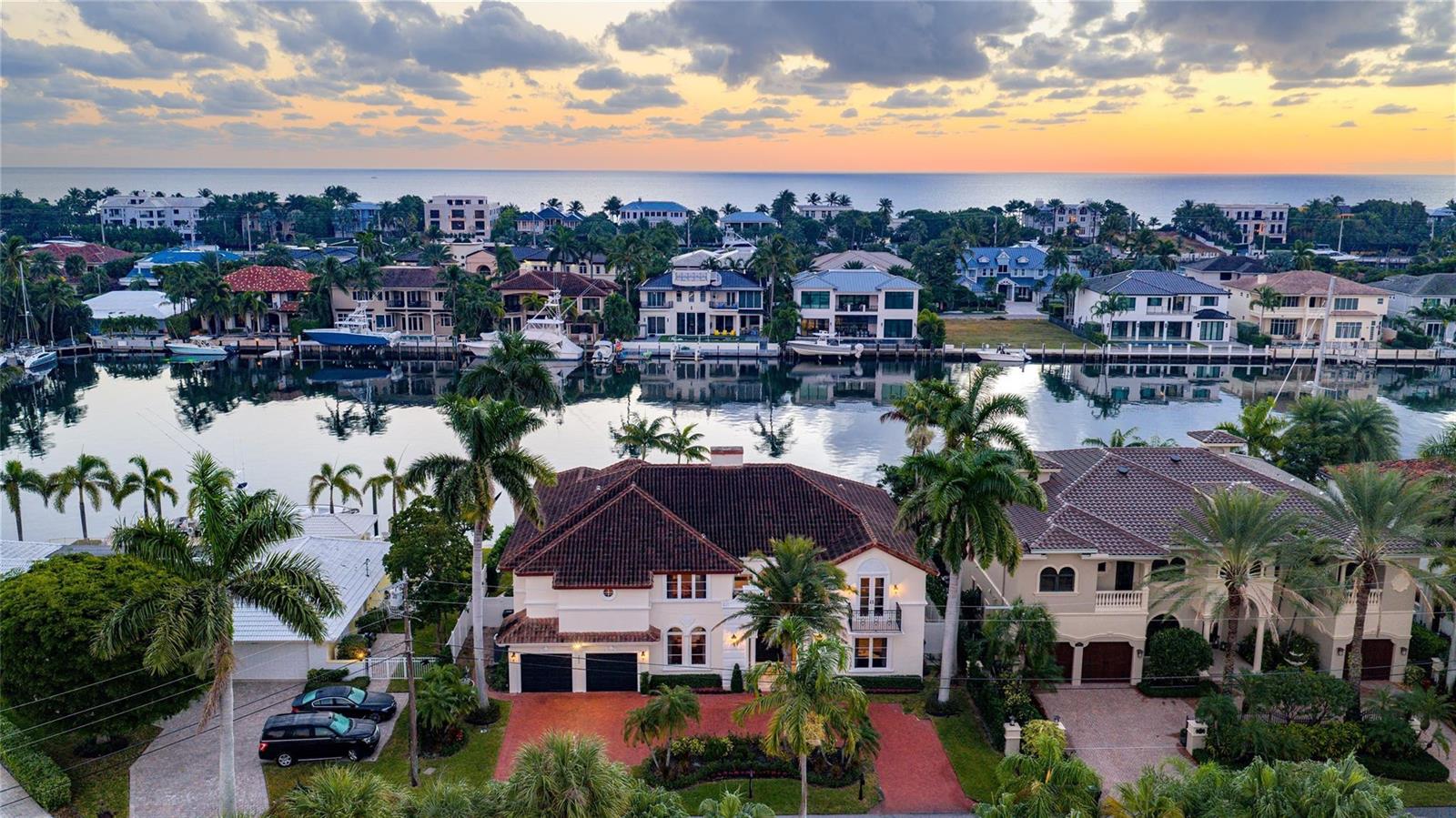 An aerial view of a waterfront mansion with a red tile roof and palm trees — 2833 NE 32nd Street, Lighthouse Point FL 33064, LIGHTHOUSE POINT, FL