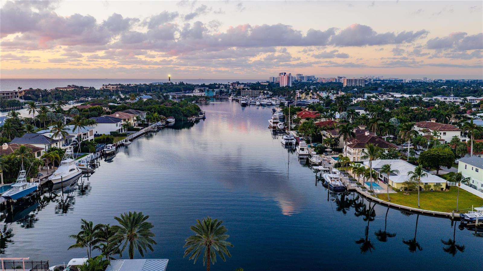 An aerial view of a canal lined with luxury homes, palm trees, and docked boats — 2833 NE 32nd Street, Lighthouse Point FL 33064, LIGHTHOUSE POINT, FL