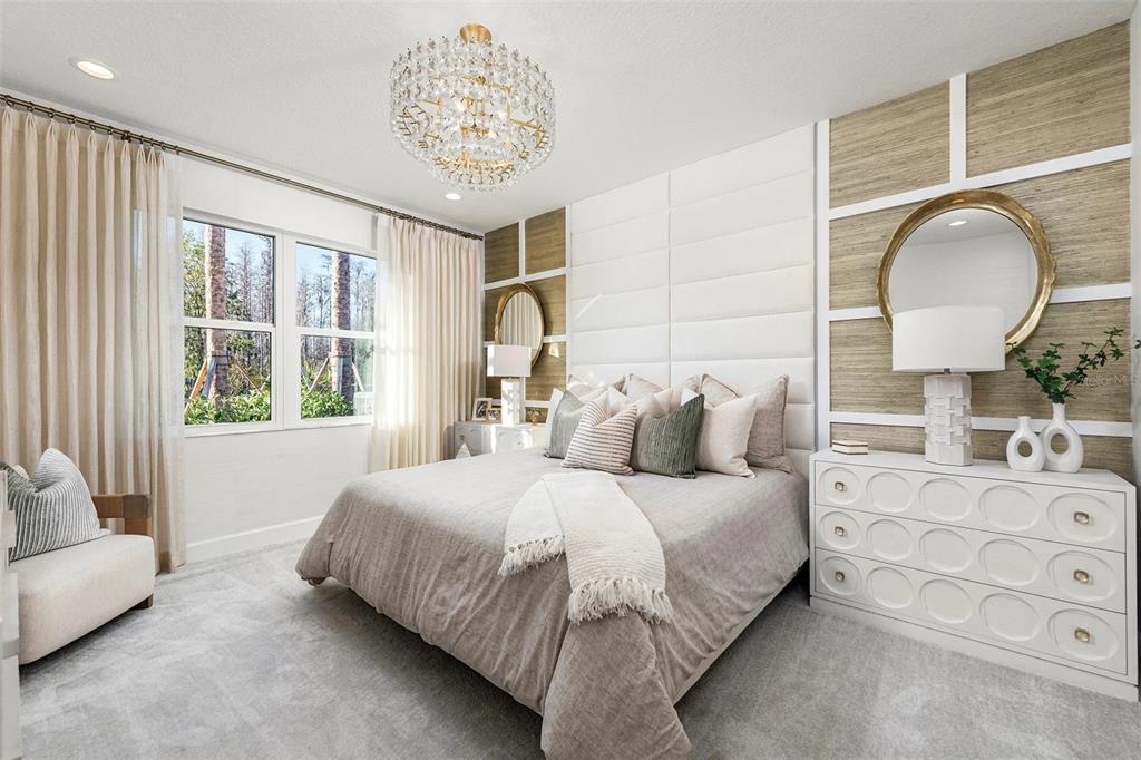 A bedroom features a tufted headboard, textured wall panels, a crystal chandelier, and a white dresser — 3380 MALTA AVENUE, WESLEY CHAPEL, FL