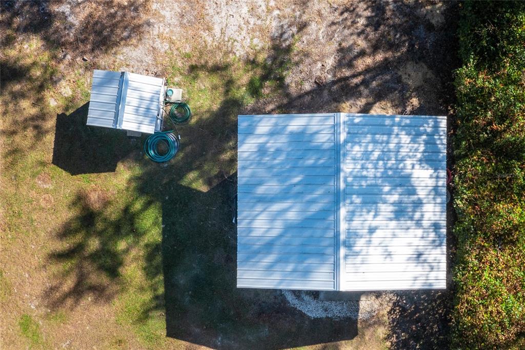 A white, single-story house with a metal roof sits on a large, grassy lawn — 6320 SE 91ST TRAIL, TRENTON, FL