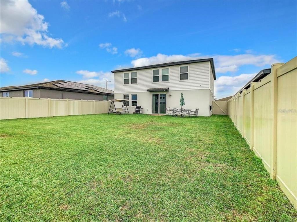 A two-story house with white siding and a large fenced-in backyard — 1210 ZAMBRANA COURT, WINTER HAVEN, FL