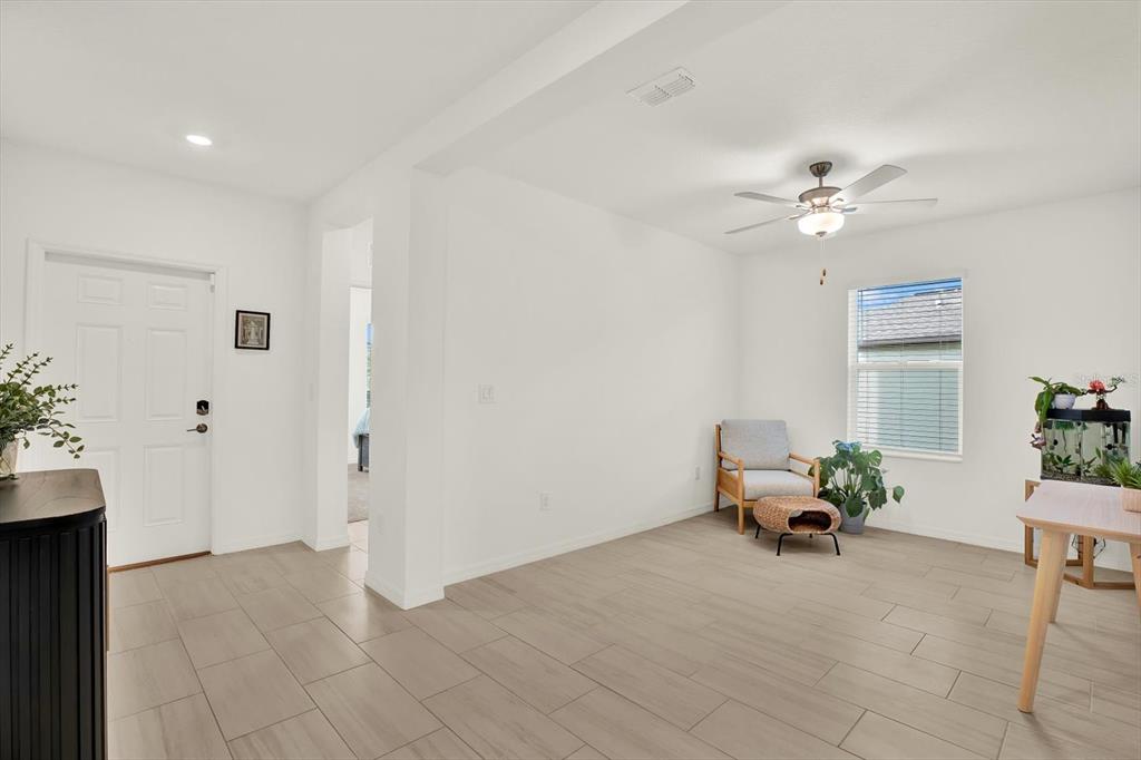 A bright room features white walls, light tile flooring, a ceiling fan, and a window — 11307 LINDEN DEPOT ROAD, SAN ANTONIO, FL
