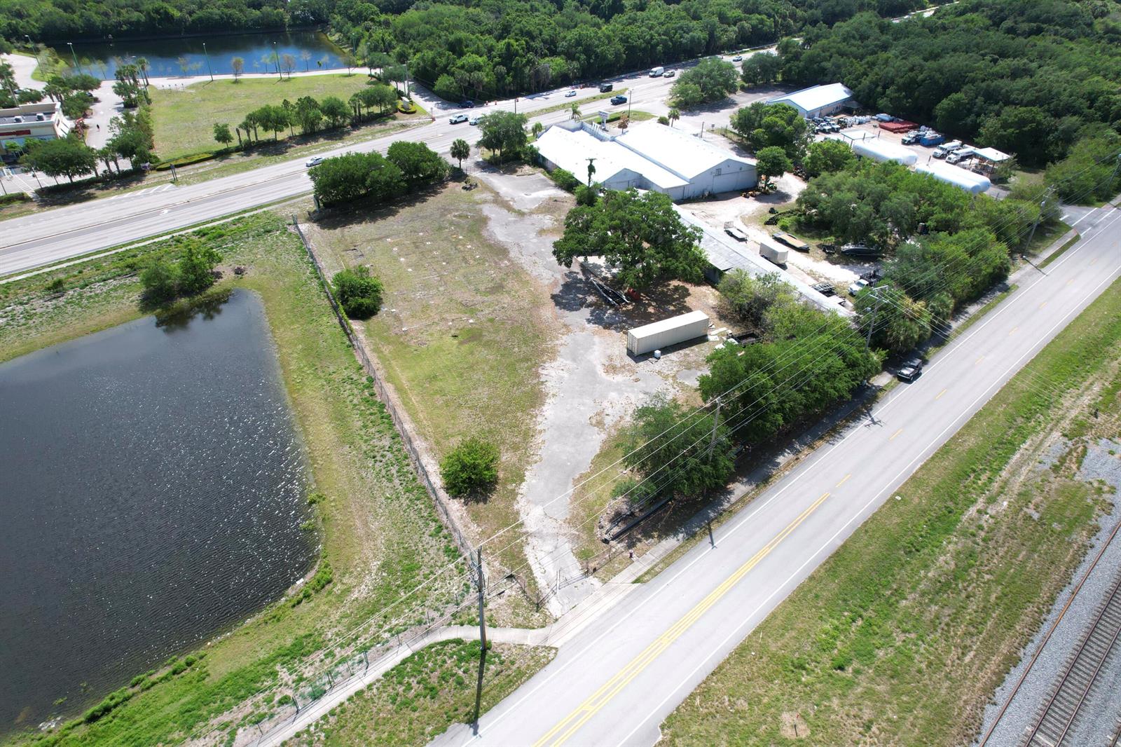 An aerial view shows a vacant lot with a storage container next to a road — 5145 Us Highway 1 Highway, Vero Beach FL 32967, VERO BEACH, FL