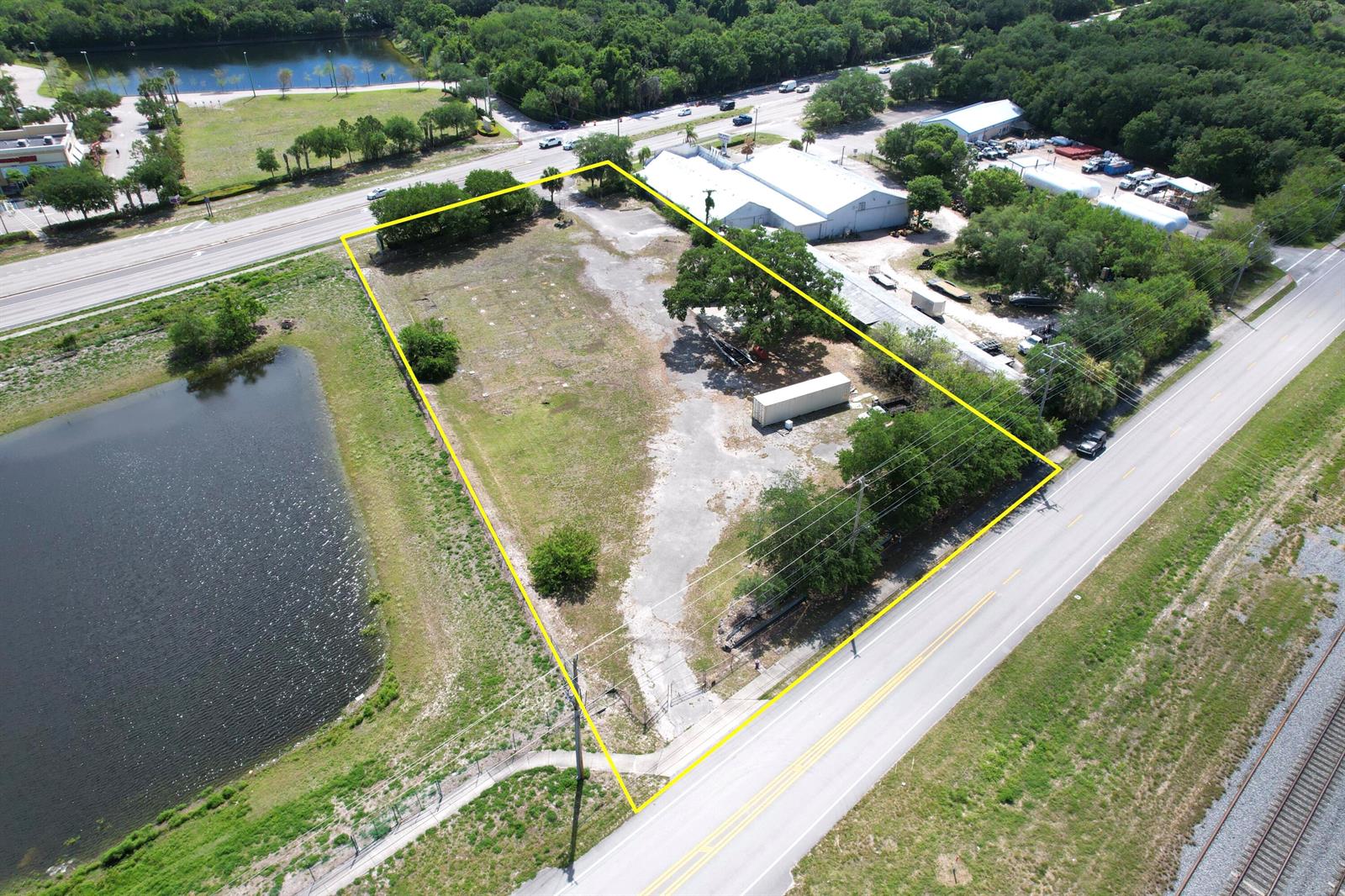 An aerial view shows a vacant, rectangular lot outlined in yellow next to a road — 5145 Us Highway 1 Highway, Vero Beach FL 32967, VERO BEACH, FL