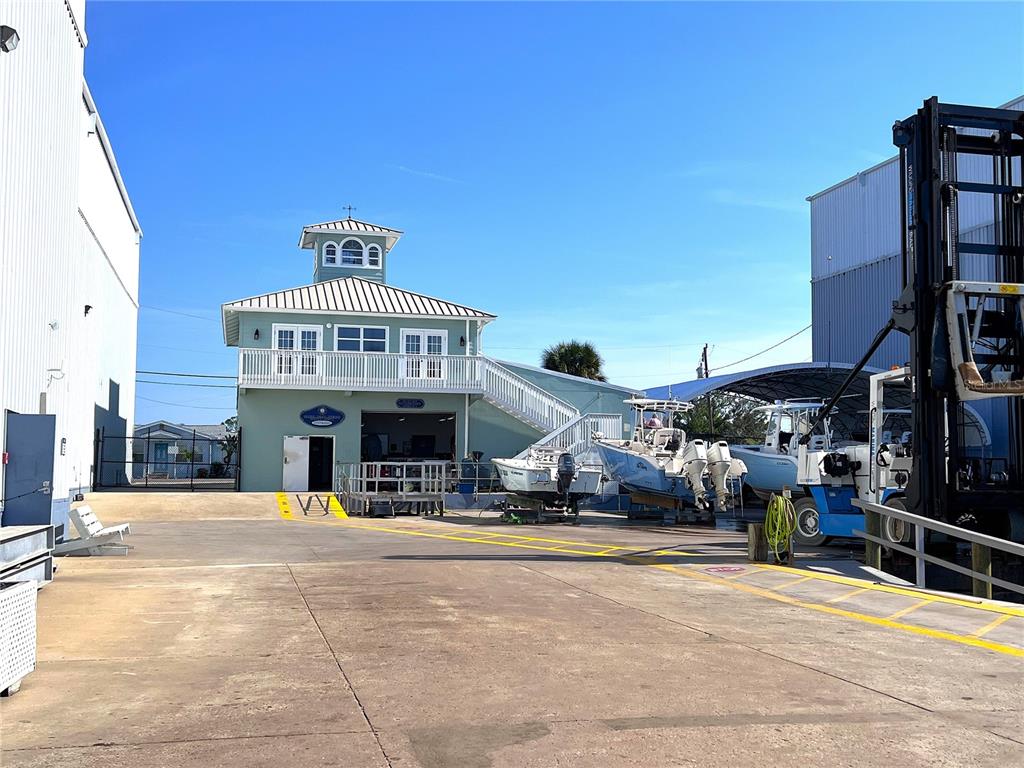 A light green two-story building with a cupola stands in a boat storage yard — 100 CIRCUIT ROAD UNIT #N-47, NOKOMIS, FL