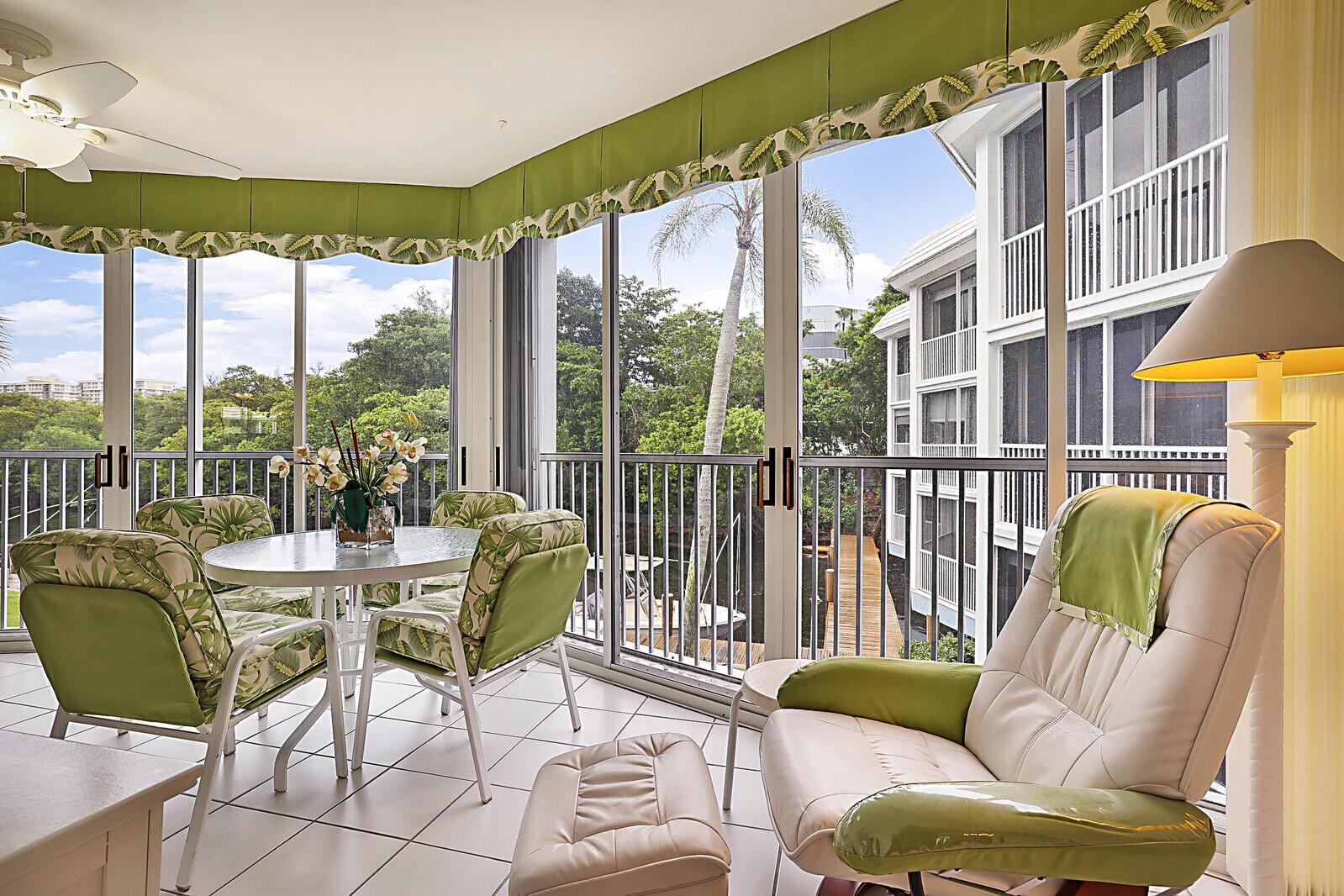 A wooden boat dock sits beside a multi-story apartment building with a small boat moored — 700 NE Harbour Terrace # 2310, Boca Raton FL 33431, BOCA RATON, FL