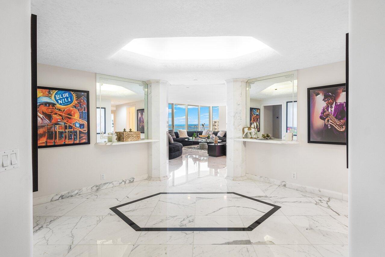 A marble-floored foyer features a hexagonal inlay, mirrored walls, and views into a living area — 4201 N Ocean Boulevard # 1801, Boca Raton FL 33431, BOCA RATON, FL
