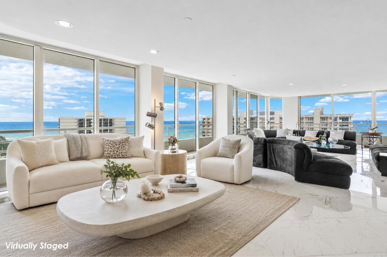 This virtually staged living room features floor-to-ceiling windows with ocean views and marble flooring — 4201 N Ocean Boulevard # 1801, Boca Raton FL 33431, BOCA RATON, FL
