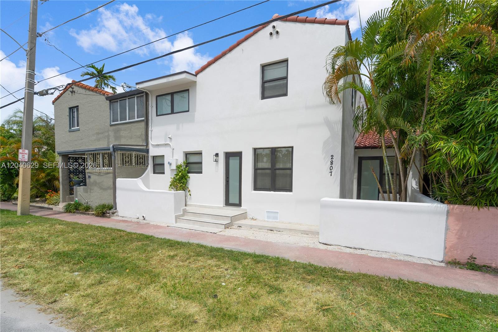 The exterior of a two-story white stucco building with a tiled roof and front entrance — 337 W 28th St, Miami Beach FL 33140, MIAMI BEACH, FL
