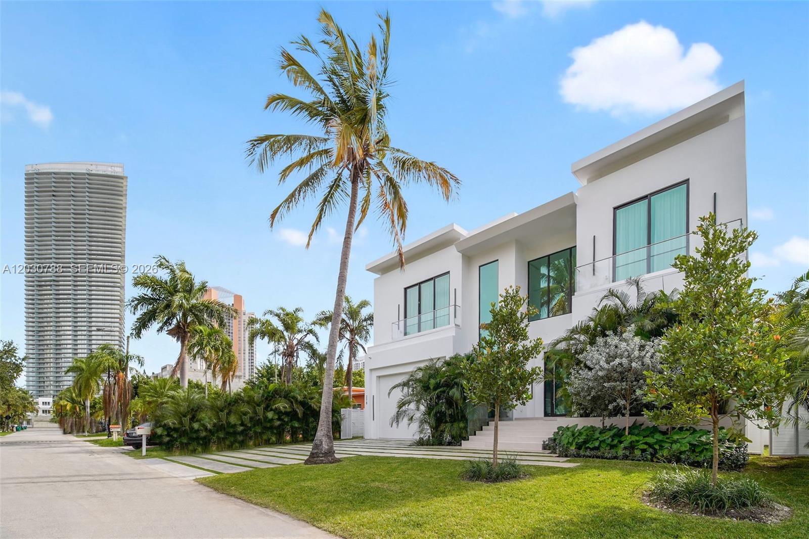 A modern two-story white house with a palm tree and a tall skyscraper nearby — 278 190th St, Sunny Isles Beach FL 33160, SUNNY ISLES BEACH, FL