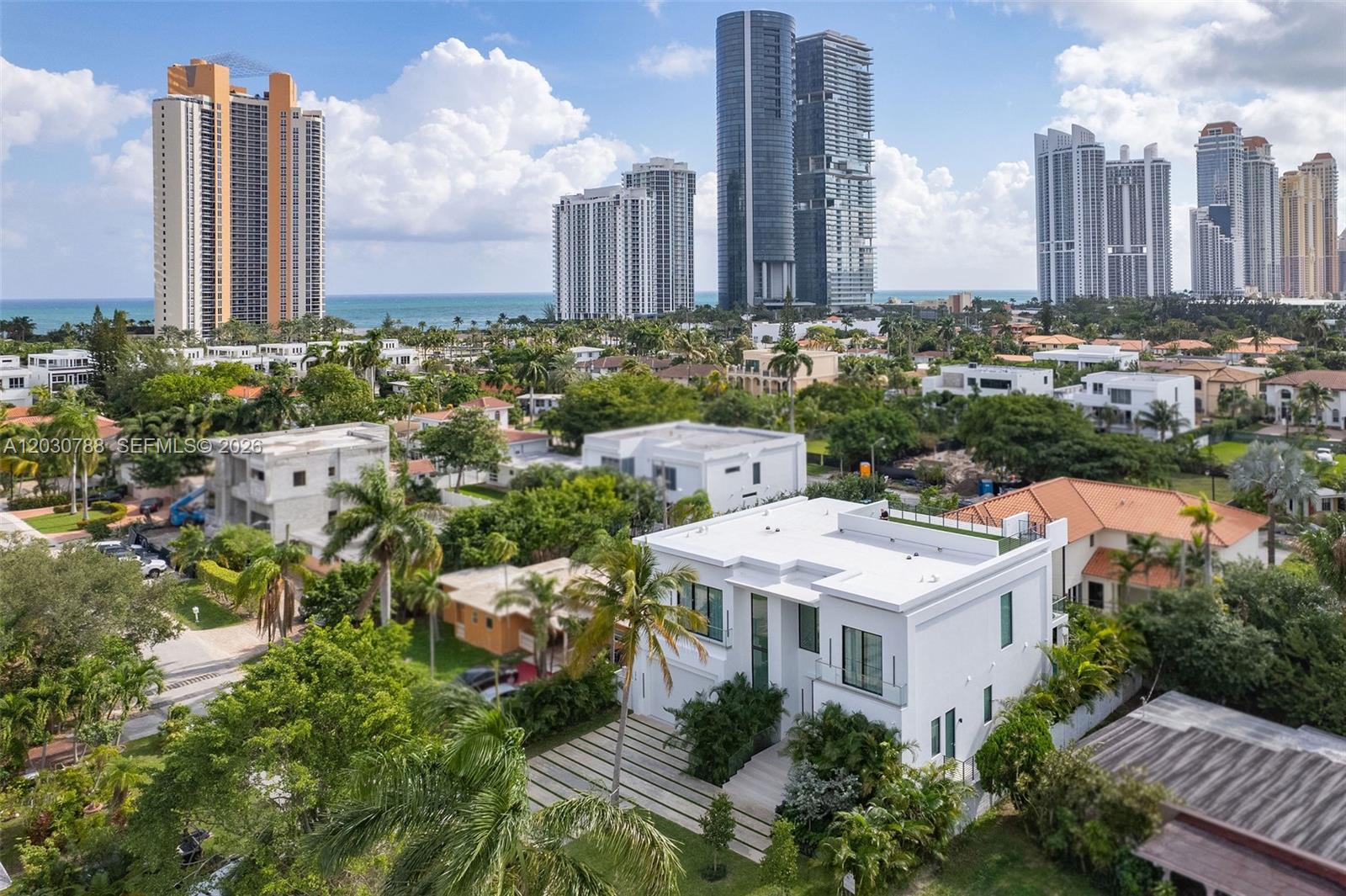 An aerial view shows a modern white house with a flat roof and palm trees — 278 190th St, Sunny Isles Beach FL 33160, SUNNY ISLES BEACH, FL