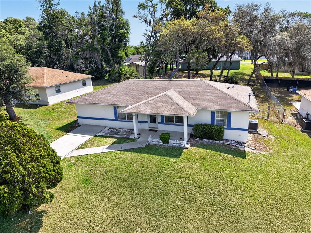 An aerial view of a single-story house with a brown roof and white exterior walls — 42 LARCH RADIAL, OCALA, FL