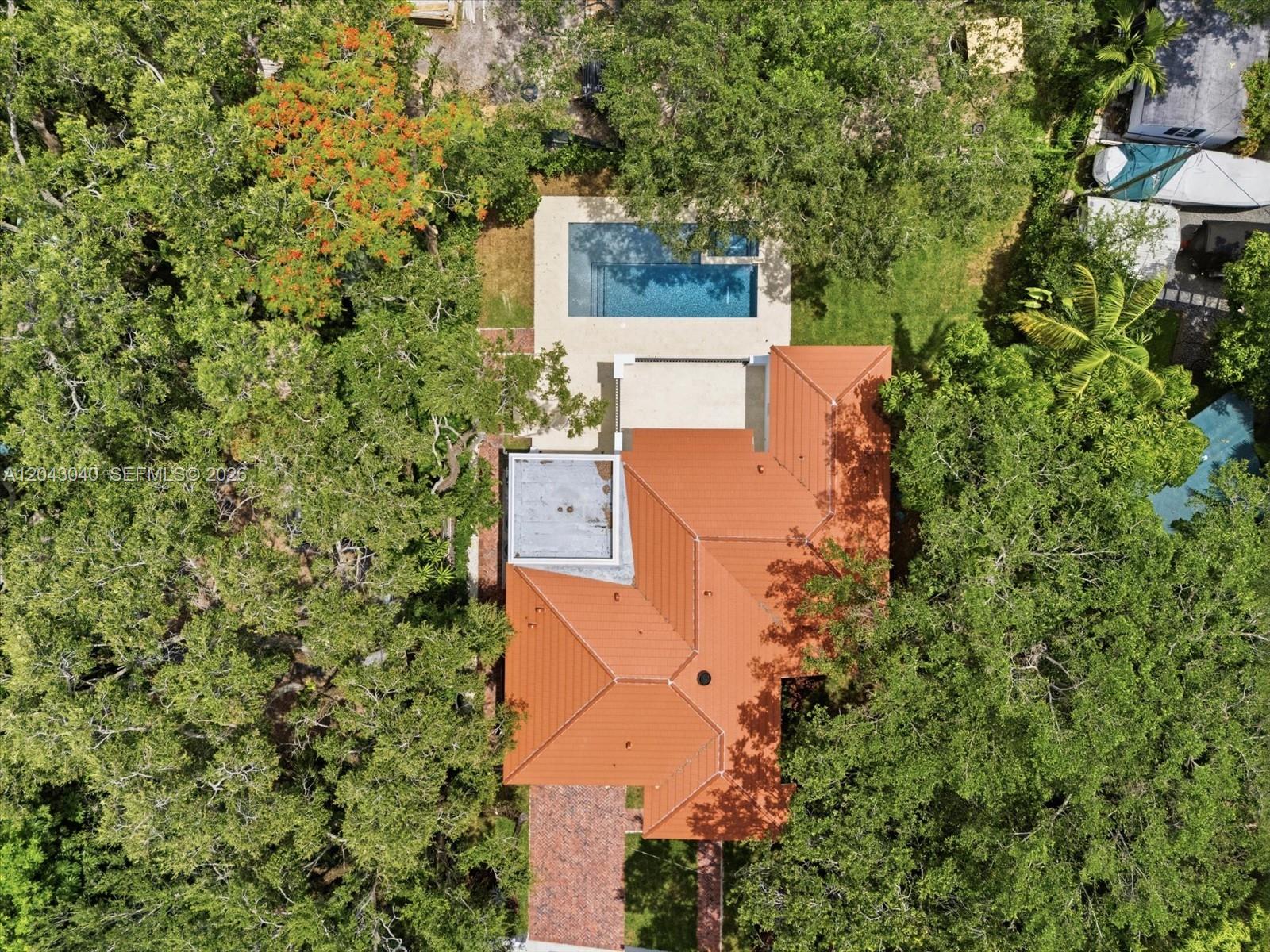 An aerial view shows a house with a red tile roof, pool, and surrounding trees — 6333 SW 69th St, South Miami FL 33143, SOUTH MIAMI, FL