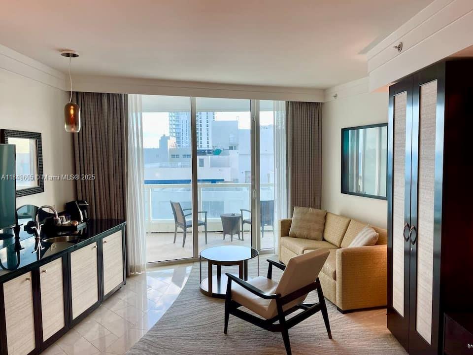 A hotel room features a kitchenette, a seating area with a sofa, and a balcony — 4391 Collins Ave # 918, Miami Beach FL 33140, MIAMI BEACH, FL