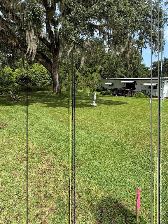 A large oak tree stands in a grassy yard near a white mobile home — 29129 JOHNSTON ROAD UNIT 2510, DADE CITY, FL