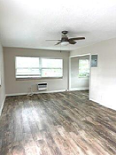 An empty room features wood-look flooring, a ceiling fan, and a window air conditioning unit — 112 Lake Avenue # 12, FL 33460, FL