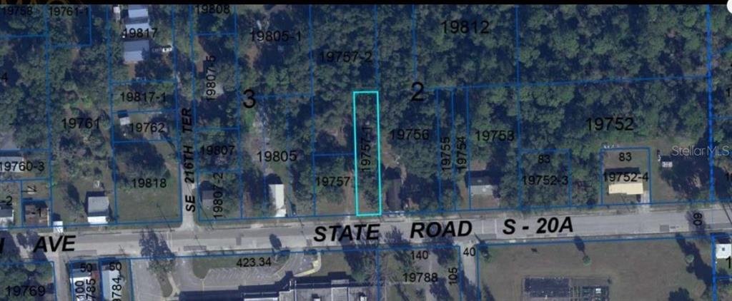 This is an aerial map showing a highlighted rectangular parcel of land along a road — 104 NW 3RD AVENUE, GAINESVILLE, FL