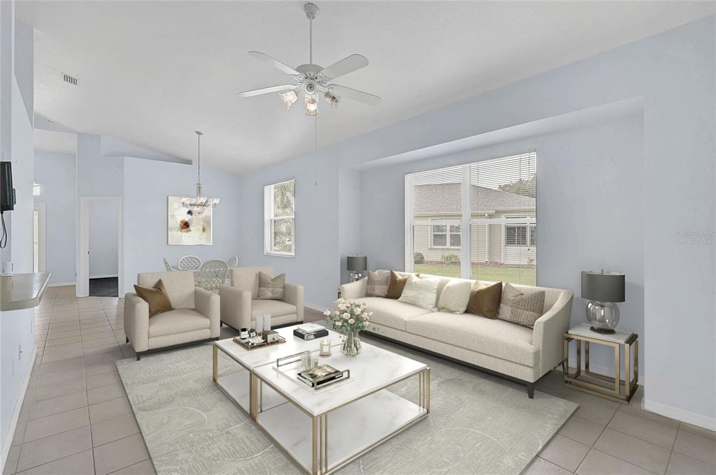 This living room features light blue walls, a white sofa, two armchairs, and a coffee table — 1439 MIMS COURT, NORTH PORT, FL