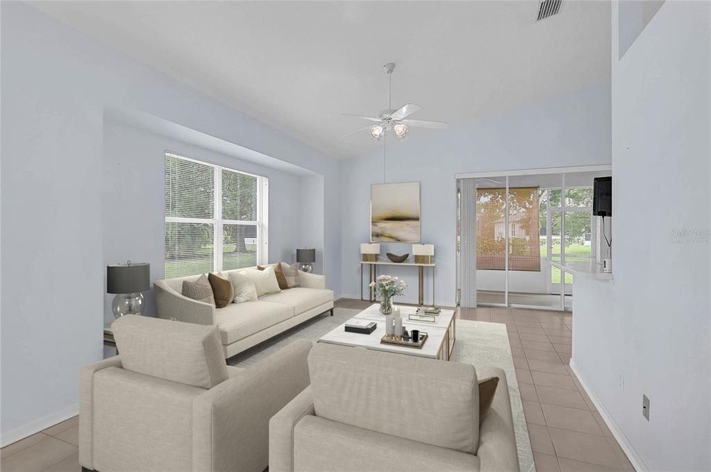 A living room features light blue walls, beige furniture, a ceiling fan, and sliding glass doors — 1439 MIMS COURT, NORTH PORT, FL