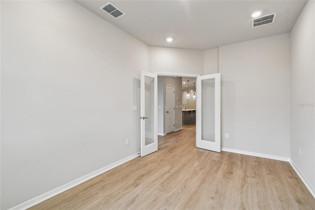 A dining room features a wooden table, four chairs, a chandelier, and a large rug — 9334 HARTLINE WAY, ORLANDO, FL