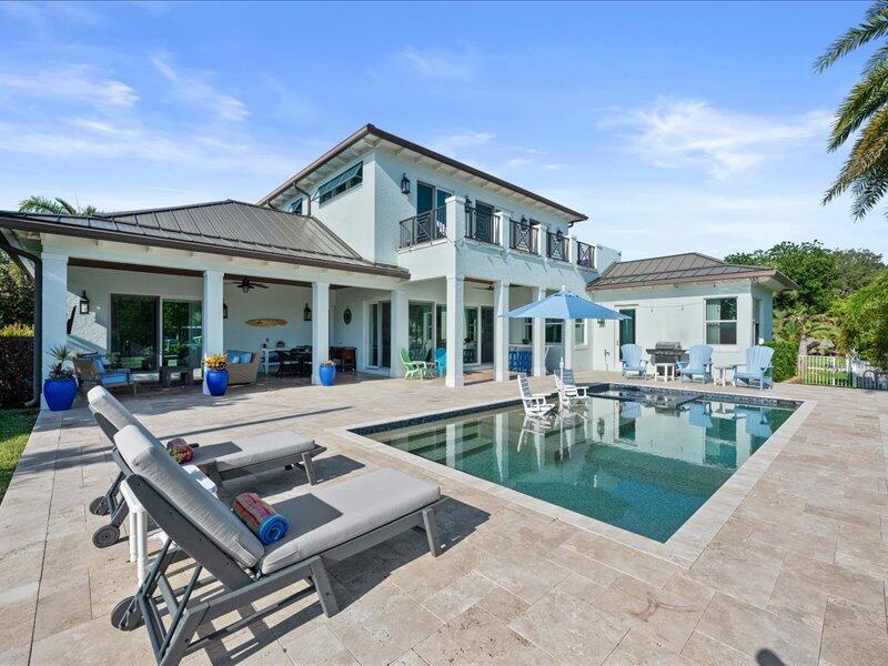 A two-story house with a pool, patio, and lounge chairs in the backyard — 205 Body Court, Jupiter FL 33477, JUPITER, FL