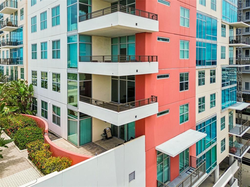 An exterior view of a modern apartment building with stacked balconies and colorful facade sections — 1120 E KENNEDY BOULEVARD W UNIT 1030, TAMPA, FL