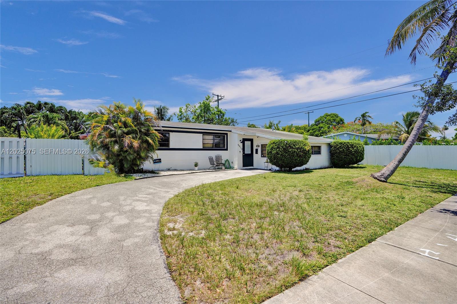 A single-story white house features a curved driveway, a front lawn, and palm trees — 9910 Bahama Dr, Cutler Bay FL 33189, CUTLER BAY, FL