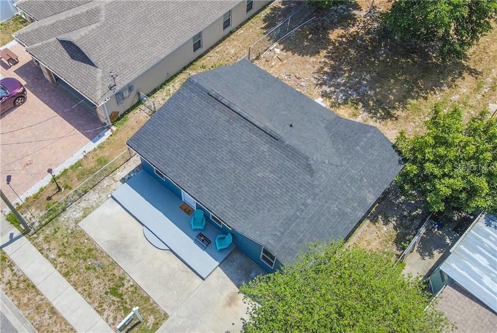 An aerial view shows a blue house with a dark shingled roof and a front porch — 7508 CAROLYN AVENUE, ORLANDO, FL