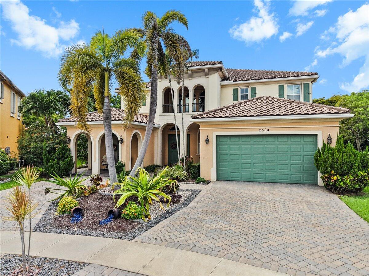 An aerial view of a two-story house with a tile roof and a paved driveway — 2524 Cooper Way, Wellington FL 33414, WELLINGTON, FL