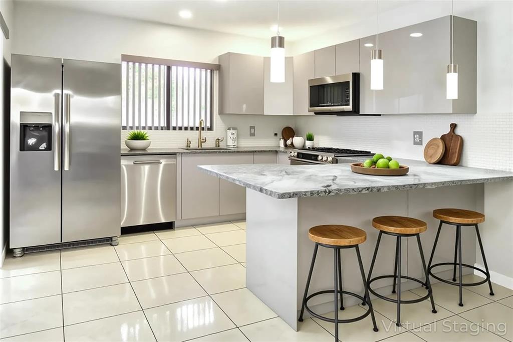 A two-story townhouse exterior features a brown wooden privacy fence and a screened-in patio area — 15202 E POND WOODS DRIVE UNIT 9, TAMPA, FL