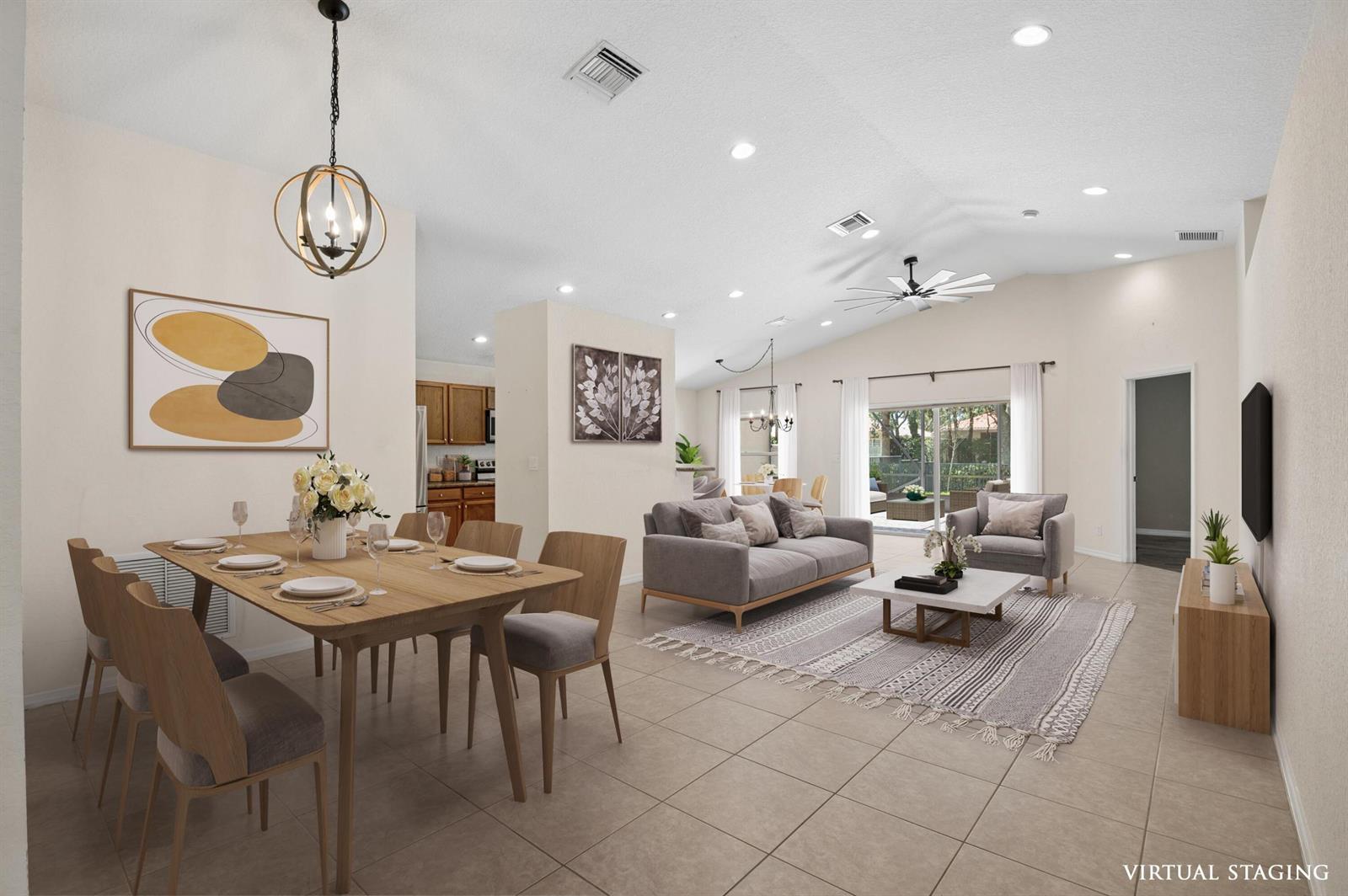 This virtually staged open-concept living and dining area features tile flooring and vaulted ceilings — 5330 Vernio Lane, Boynton Beach FL 33437, BOYNTON BEACH, FL