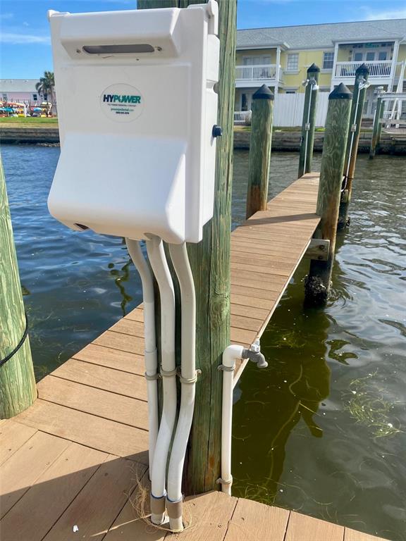 A white electrical power pedestal is mounted on a wooden piling on a boat dock — 0 NE BEACH DRIVE SE UNIT 95SS, ST PETERSBURG, FL