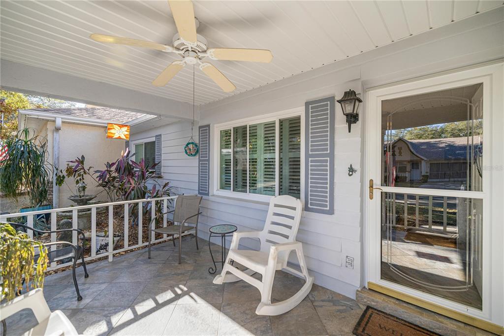 A single-story house with light gray siding, a covered front porch, and a two-car garage — 9438 SW 85TH AVENUE UNIT B, OCALA, FL