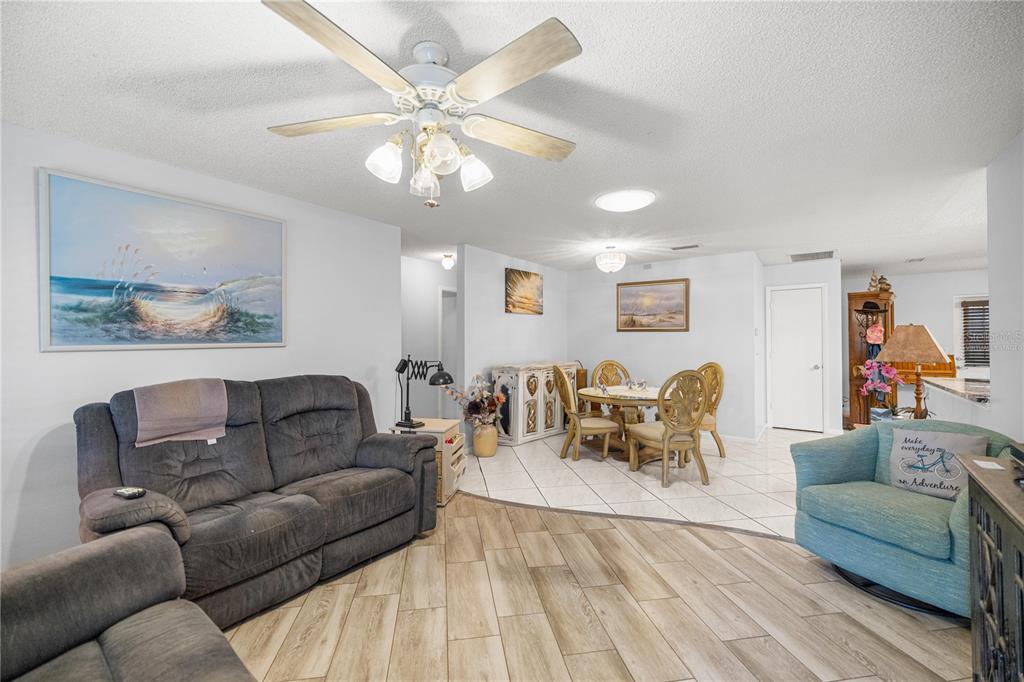 A single-story house with a covered front porch, a lawn, and a large tree — 9438 SW 85TH AVENUE UNIT B, OCALA, FL