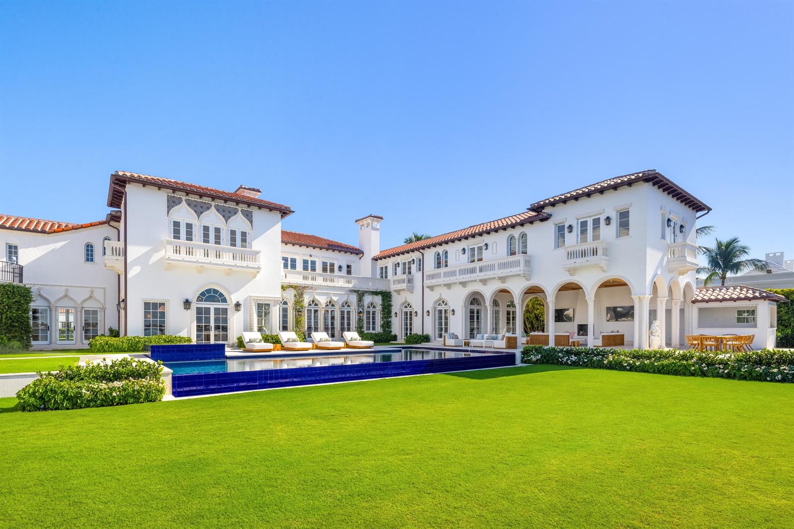 A large white Mediterranean-style mansion features a swimming pool and a expansive green lawn — 800 S County Road, Palm Beach FL 33480, PALM BEACH, FL