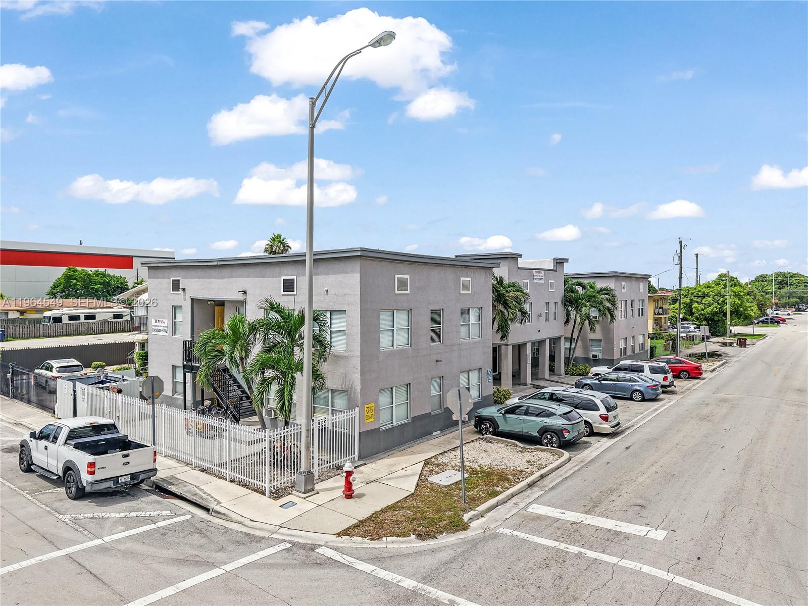 An exterior view of a two-story apartment building with a parking lot and street — 508 W 1st Ave, Hialeah FL 33010, HIALEAH, FL