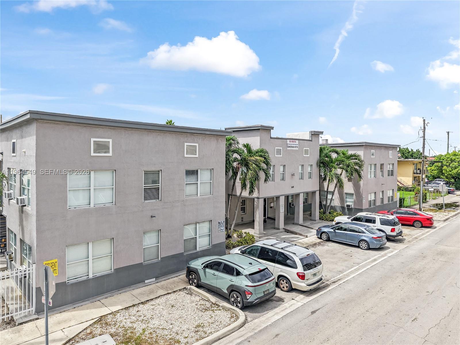 An exterior view of a multi-story apartment building with a parking lot in front — 508 W 1st Ave, Hialeah FL 33010, HIALEAH, FL