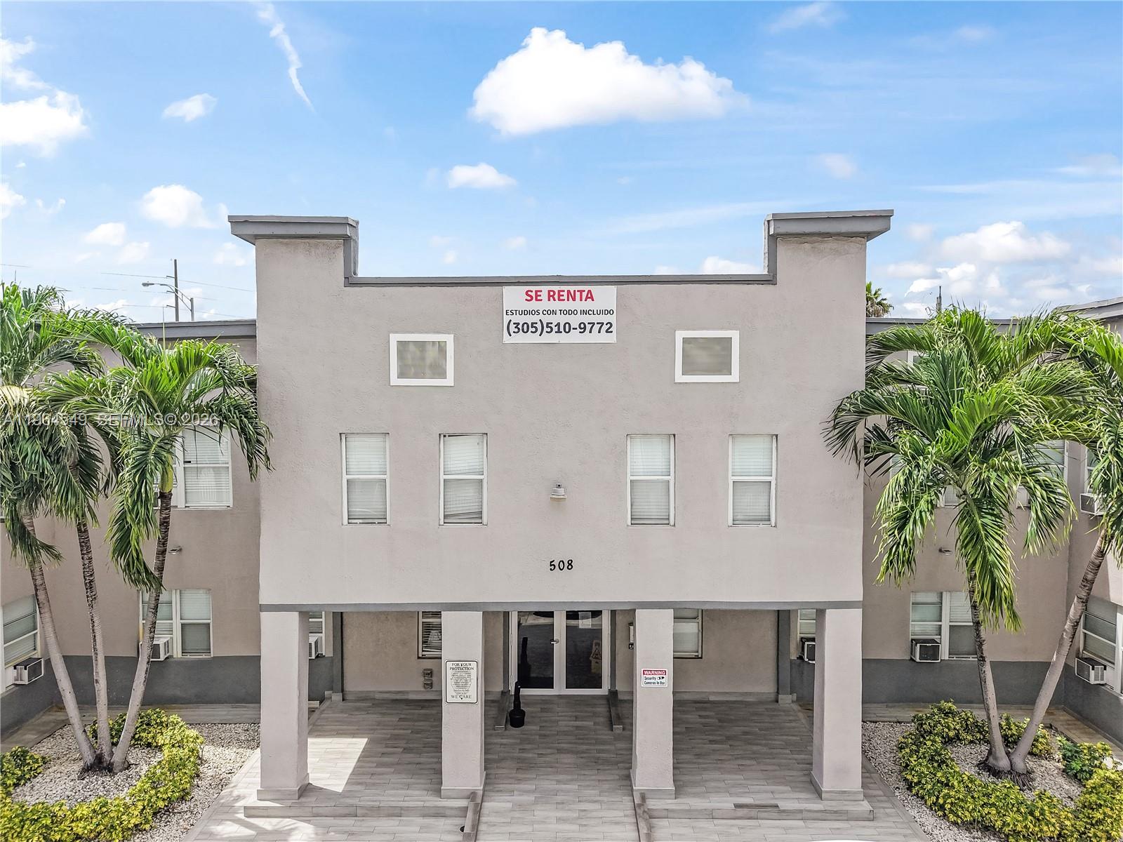 An exterior view of a two-story apartment building with palm trees and a rental sign — 508 W 1st Ave, Hialeah FL 33010, HIALEAH, FL