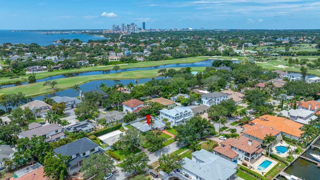 An aerial view shows a residential neighborhood with a red arrow pointing to a house — 328 BAYVIEW DRIVE NE, ST PETERSBURG, FL