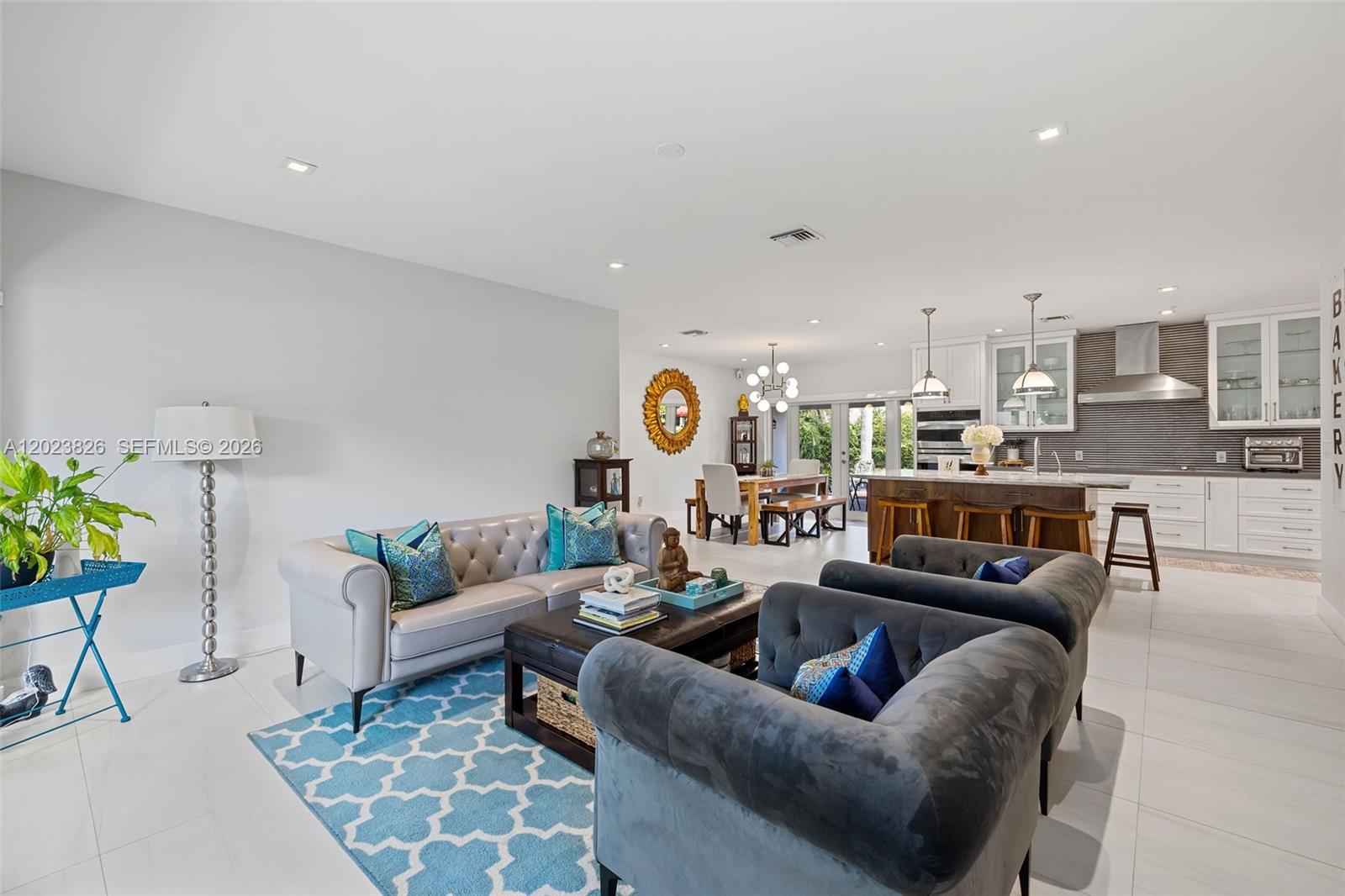 An open-concept living room and kitchen featuring white tile floors and modern furniture — 7980 SW 108th St, Miami FL 33156, MIAMI, FL