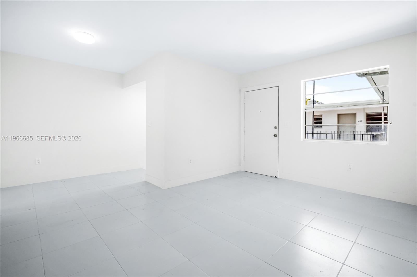 A bright, empty room features white walls, light gray tile flooring, and a single window — 10375-35-55 SW 40th St # 0, Miami FL 33165, MIAMI, FL